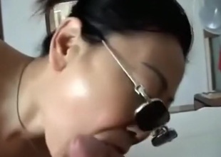 Oriental girl with sunglasses sucks cock, while getting fingered.